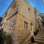 Corner view of detached stone house on steps – Hvar renovation property project in Hvar Town.