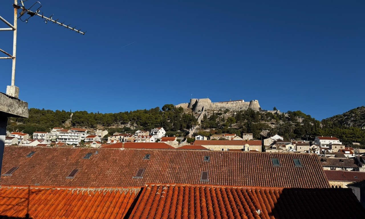 View from the property roof terrace across Hvar Town rooftops to Fortica fortress.